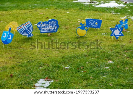 Hanukkah sign lawn display on a green grassy lawn in front of a house