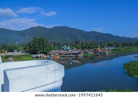 View of river with a mountain in the morning. riverside lifestyle in Asia. Houses by the river 
