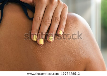 Woman skin shoulder with waterdrops and mist on a hot summer day Royalty-Free Stock Photo #1997426513