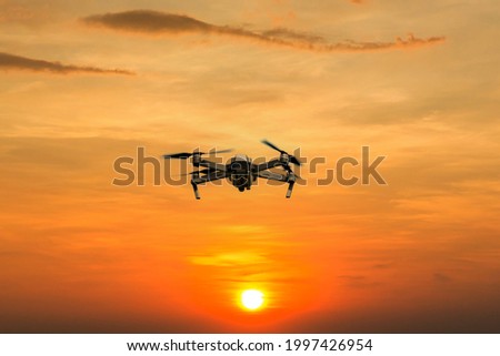 Drone copter flying with digital camera. Drone with high resolution digital camera. Flying camera take a photo and video. The drone with professional camera takes pictures of the misty mountains.