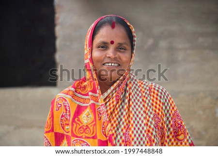 Indian Rural Woman Smiling and Standing Royalty-Free Stock Photo #1997448848