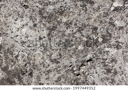 Texture background of old gray stone wall with uneven surface