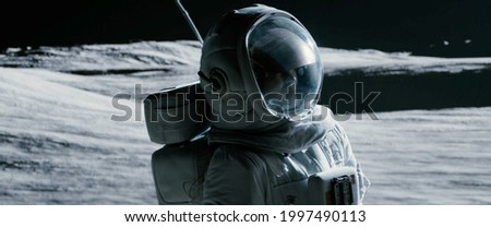 Portrait of Asian lunar astronaut opens his visor while exploring Moon surface Royalty-Free Stock Photo #1997490113