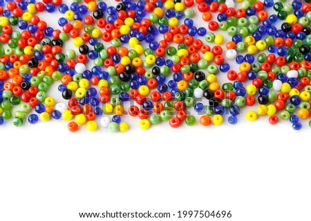 lots of small, multi-colored glass beads, isolated on a white background, top view, copy space, Soft focus, selective focus