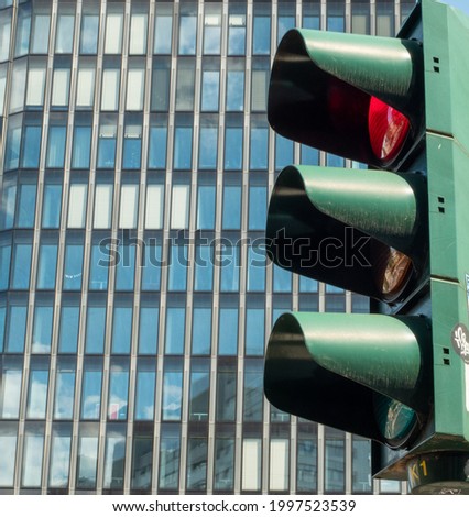 Traffic light on the background of a glass building