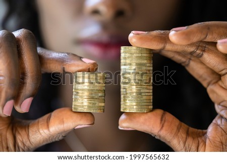 Compare Wage Gap And Tax Differences. Equal Pay Royalty-Free Stock Photo #1997565632