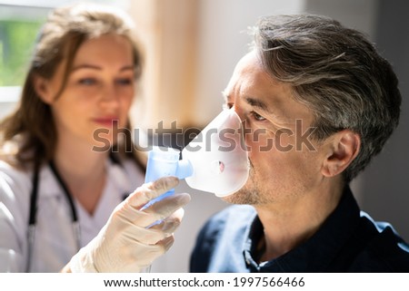 Asthma COPD Breath Nebulizer And Mask Given By Doctor Or Nurse Royalty-Free Stock Photo #1997566466