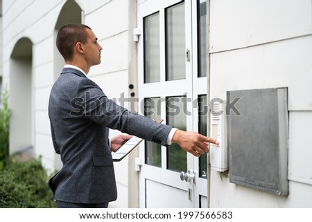 Bailiff Debt Collector Touching Doorbell. Confiscation And Seizure Royalty-Free Stock Photo #1997566583