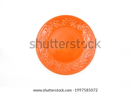 orange embroidered plate on a white background