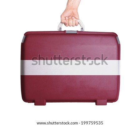 Used plastic suitcase with stains and scratches, printed with flag, Latvia