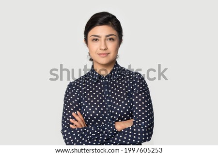 Portrait of young successful Indian woman worker employee stand isolated on grey studio background feel confident. Millennial mixed race female intern show motivation. Employment, hr concept.