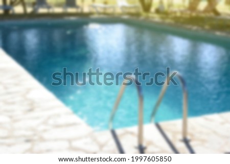 Summer background with pool out of focus, copy space.