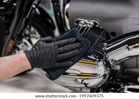 Polishing and cleaning chrome motorcycle part.