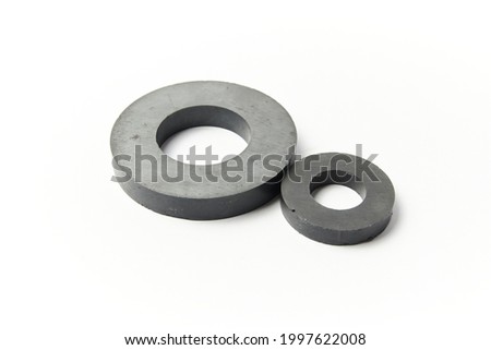 Circular black ferrite ring shaped magnets isolated on a white background Royalty-Free Stock Photo #1997622008