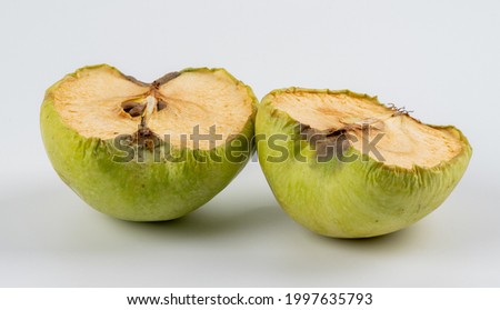 Inside of an old apple on white background. Wrinkled apple texture with white background. Shriveled apple.  Royalty-Free Stock Photo #1997635793