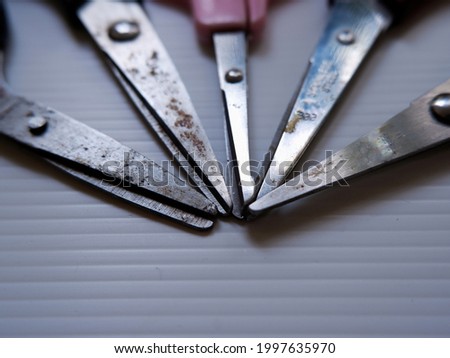 Angle view of set of rusty scissors with different size and color in white background.