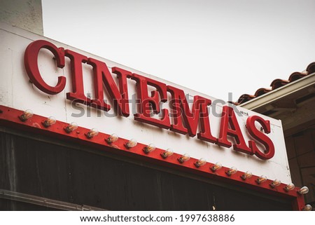 Aged and worn cinemas sign on building