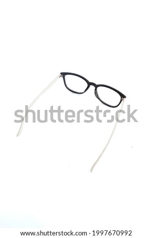 isolation glasses on white background. black and white combination oval eyeglass frames. oval eye glasses frame in the photo from above on a white background