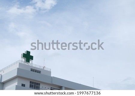 Hospital building and Green Medical Cross sign. concept of Medical background.