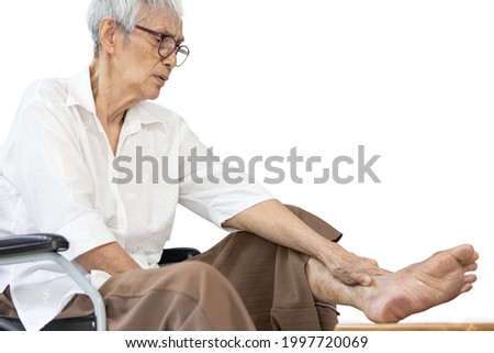 Asian senior woman massaging ankle and feet,old elderly had beriberi,cramp,numbness in her feet,sore toe joints,peripheral neuropathy disease,pain and swelling in the ankle bone,leg muscle weakness