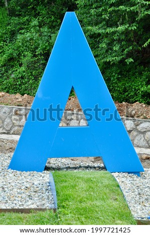 Sculpture of the letter "A" in a city park 
