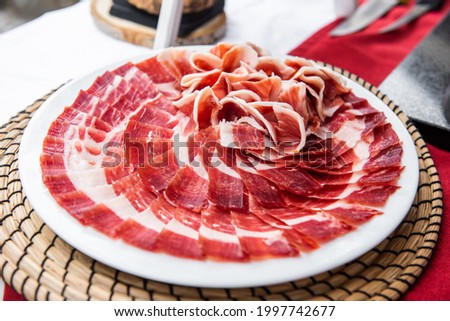 Plate of acorn-fed Iberian ham on the table at an event Royalty-Free Stock Photo #1997742677