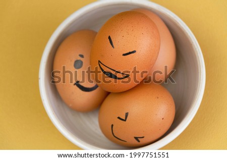 Closeup Egg with brown shell paint by black ink in Smile face theme,put on background,blurry light around
