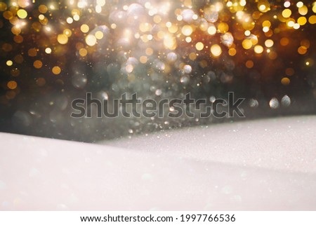 background of abstract silver, gold and black glitter lights. defocused