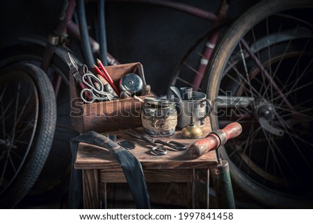 Vintage bike fix service with tools and parts. Vulcanization workshop In an old wooden shed.