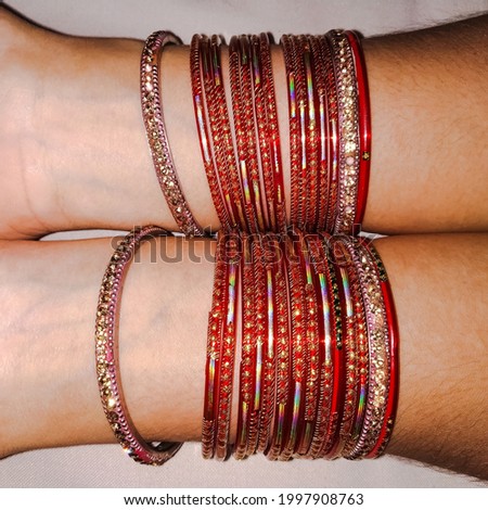 Picture of bangles or chudi in hand of an indian married woman, with shallow depth of filed, which gives a dramatic look.