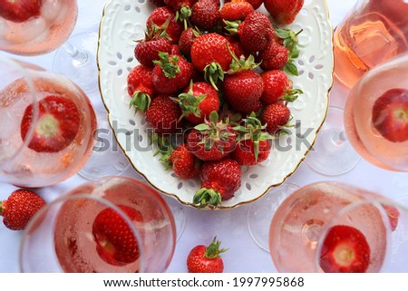 Creative composition with rose wine and delicious strawberries on the white background, top view . Royalty-Free Stock Photo #1997995868