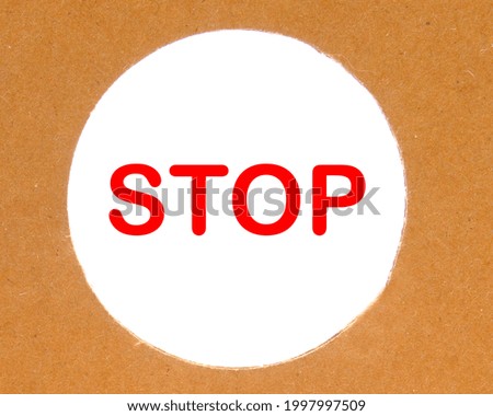STOP lettering in a round paper hole on a white background