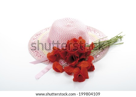 Light pink girlish summer hat and a bunch of poppies