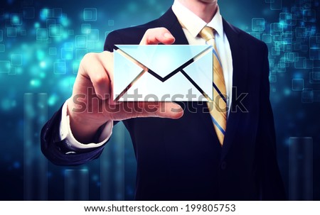 Business man with email envelopes on blue technology background