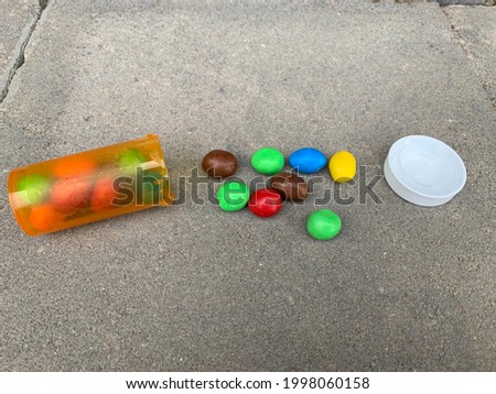 A concept picture with candy in and around a pill bottle representing how pills are often prescribed or taken like candy to address illness
