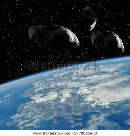 Earth and asteroids above it. The elements of this image furnished by NASA.

