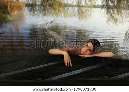 cosplay. bored mermaid lies near the boat in the lake