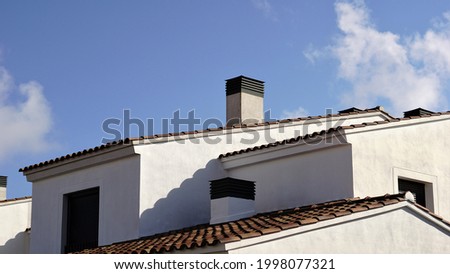 roof of modern house with white facade against the sky