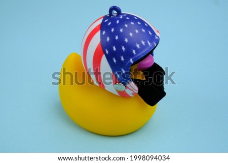 Yellow rubber duck wearing a helmet with the usa symbol. 4th of july. American flag.