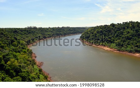 The border bend of the Parana River. The sky and the forest on the banks of the river. Royalty-Free Stock Photo #1998098528