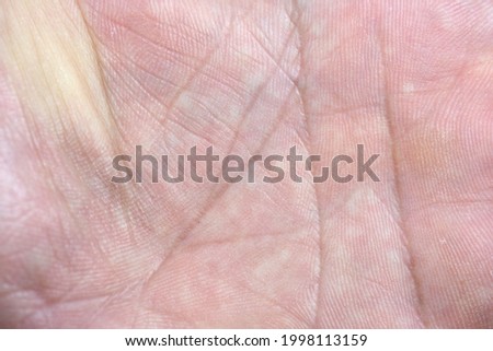 Close up of human hand palm with visible lines. Skin texture background. Background from the lines on the hand. Macro. Human skin, closeup of the inner surface of a male hand.