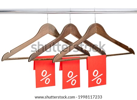 three wooden hangers with red price tags. isolated on white background