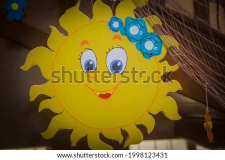 multicolored applique, yellow sun made of paper,