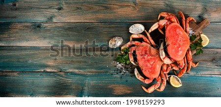 Freshly cooked crab with oyster shells and seasoning in flat lay format for seafood background concept   Royalty-Free Stock Photo #1998159293