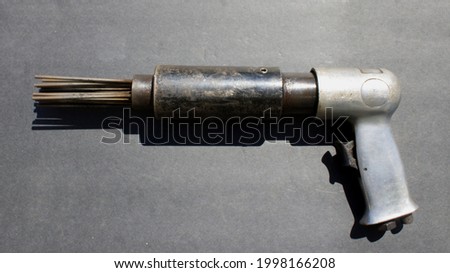 An Air Needle Scaler on a Black Background Royalty-Free Stock Photo #1998166208