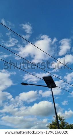 Picture of an electric pole with a beautiful blue sky