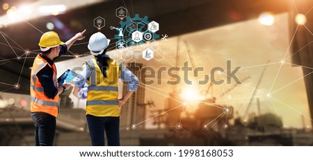 Engineer and Architect analyzing of under construction project with technology and new innovative on digital tablet and icon network of construction on virtual interface.  Royalty-Free Stock Photo #1998168053