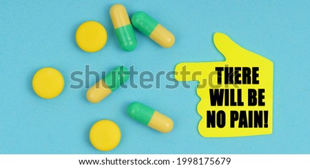 Medicine and health concept. On a blue background, there are pills and a hand-sticker with the inscription - There will be no pain
