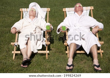 Mature couple detoxing during a do it yourself spa day in their backyard Royalty-Free Stock Photo #199824269