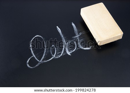 The word DEBT written in chalk on a chalkboard being rubbed out by an eraser Royalty-Free Stock Photo #199824278